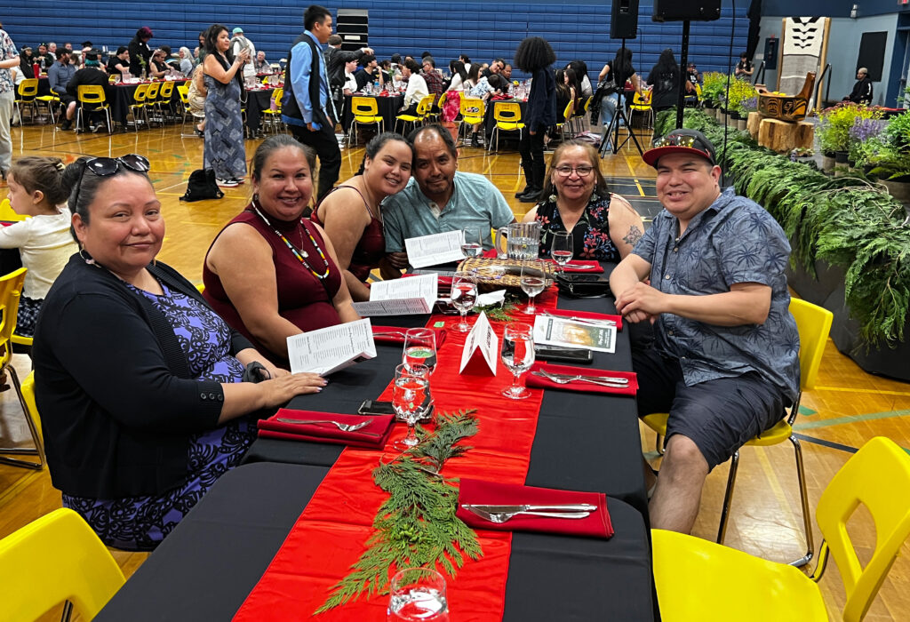Family smiling at a dining table