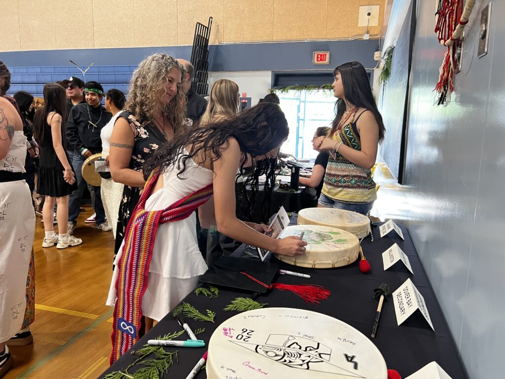 student signing her school's drum