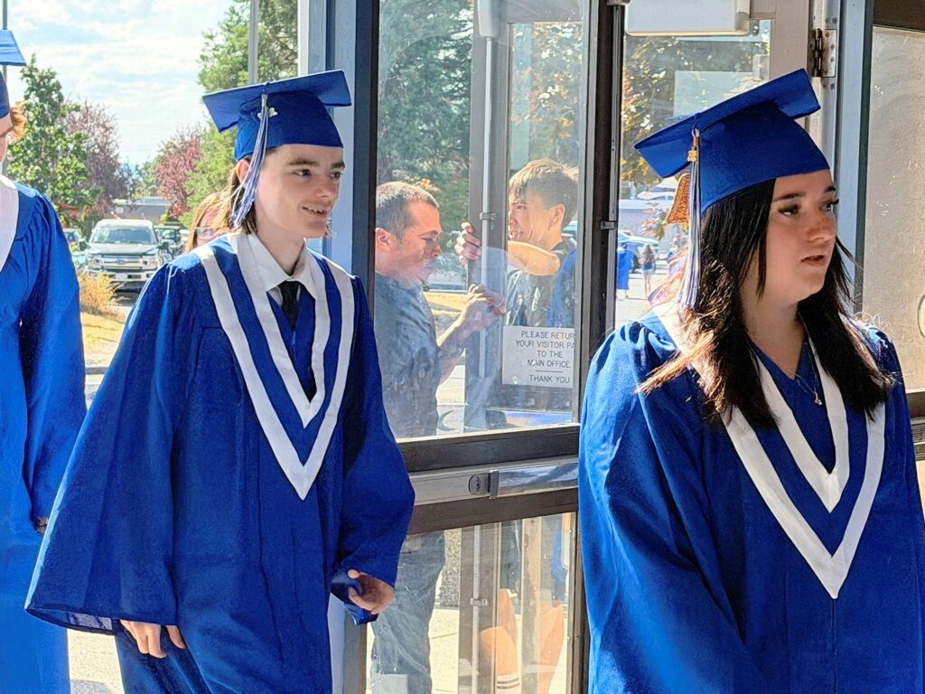 Ladysmith grads enter the school in their robes before the ceremony