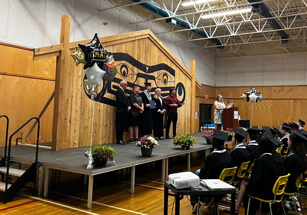 Island ConnectED grad accepting diploma on stage