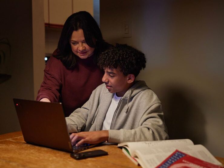 Mother and son on laptop together